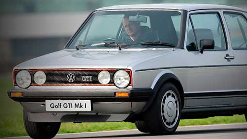 Image of front of classic silver Golf GTI Mk II with male driver