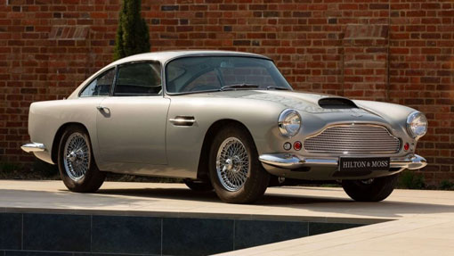 Image of classic silver Aston Martin DB4 parked on marble floor