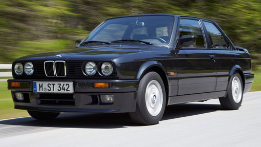 Image of classic black BMW 3 series driving on a road