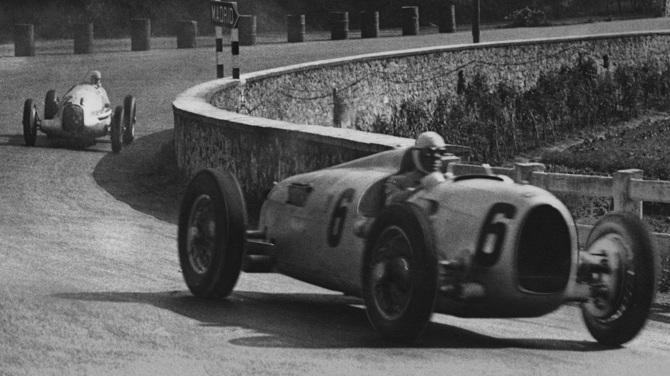 Varzi, driving an Auto Union Type B, leads the 1935 Spanish Grand Prix. After sustaining cuts to his face when a stone smashed the windscreen, Varzi handed the car over to Paul Pietsch, but the pair ultimately retired from the race with gearbox issues.