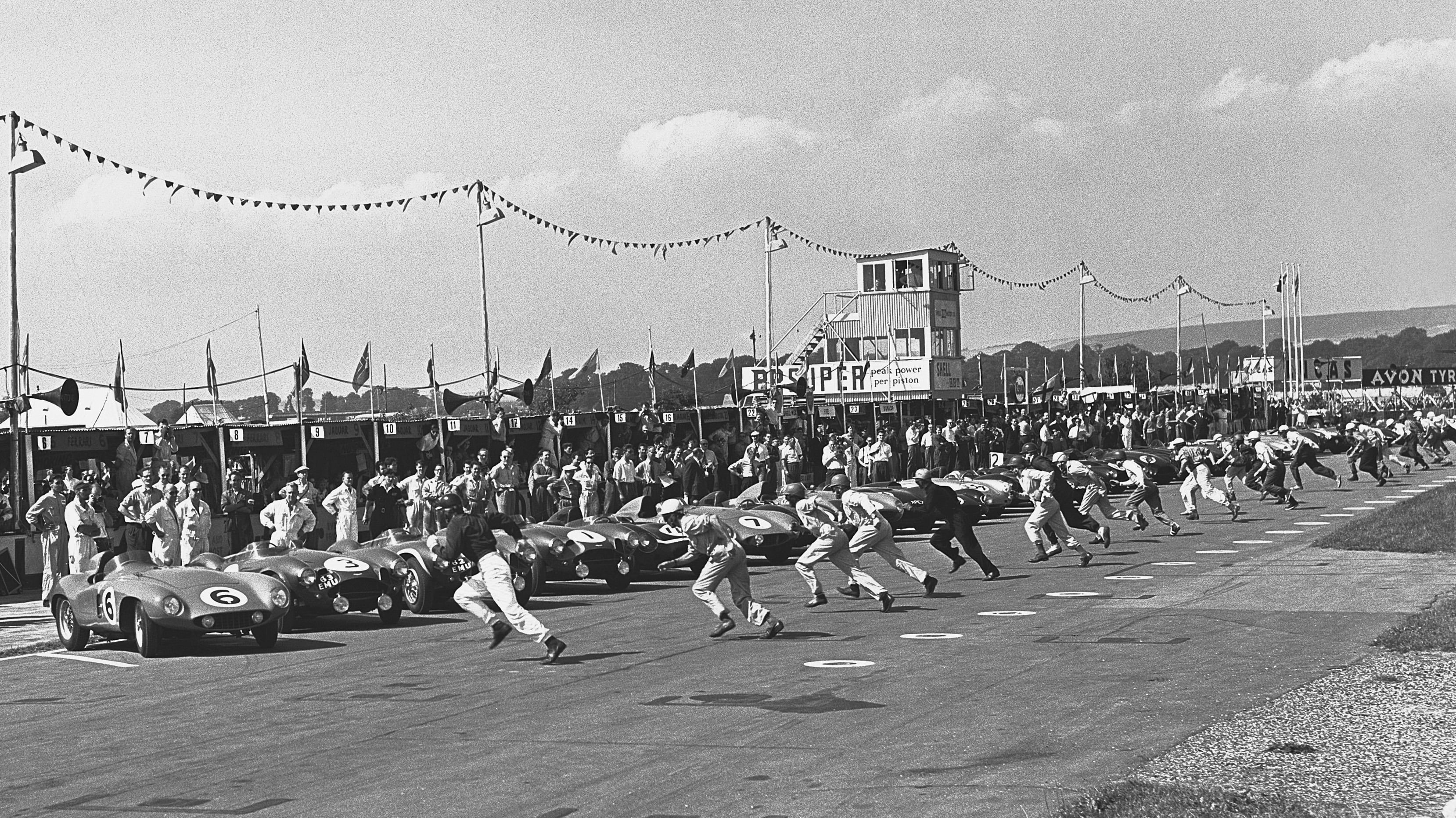 The 1955 Goodwood 9 Hours Race gets underway at the Goodwood Motor Circuit with a Le Mans-style start at exactly 3pm.