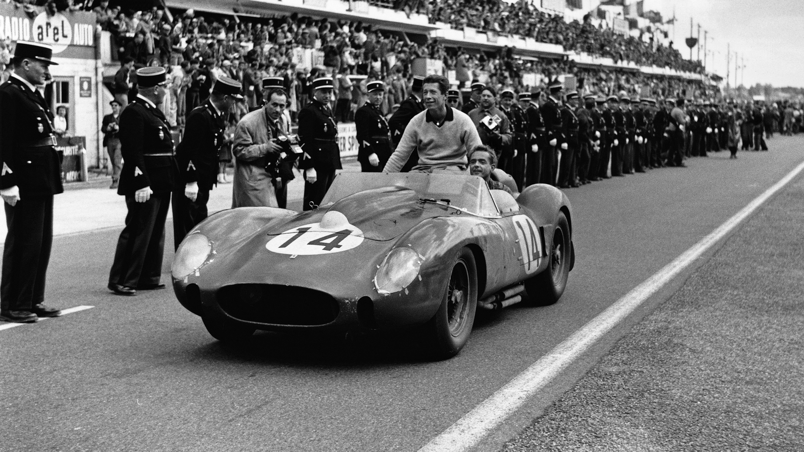 Olivier Gendebien and Phil Hill celebrate their victory with the #14 Ferrari 250 TR at the 1958 Le Mans 24 Hours.