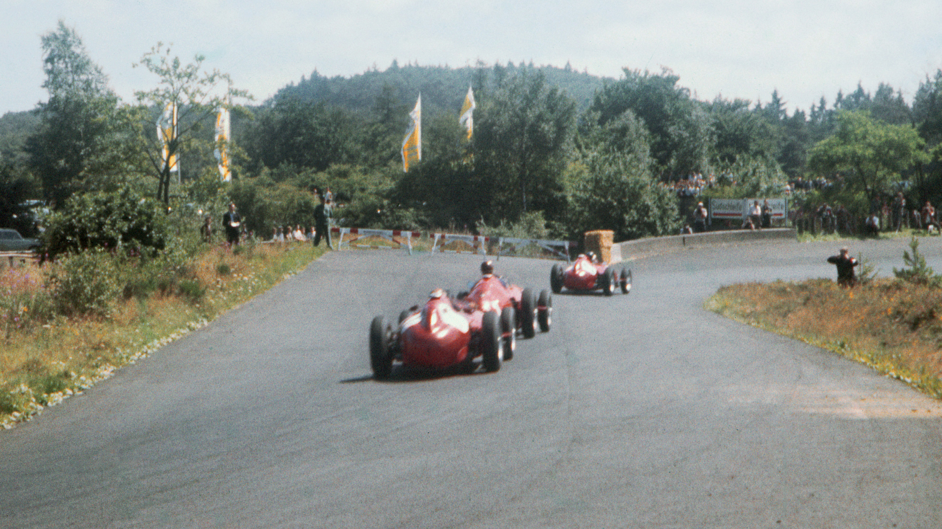 Fangio sandwiched between the Lancia-Ferrari D50s of Mike Hawthorn and Peter Collins during the 1957 German Grand Prix.