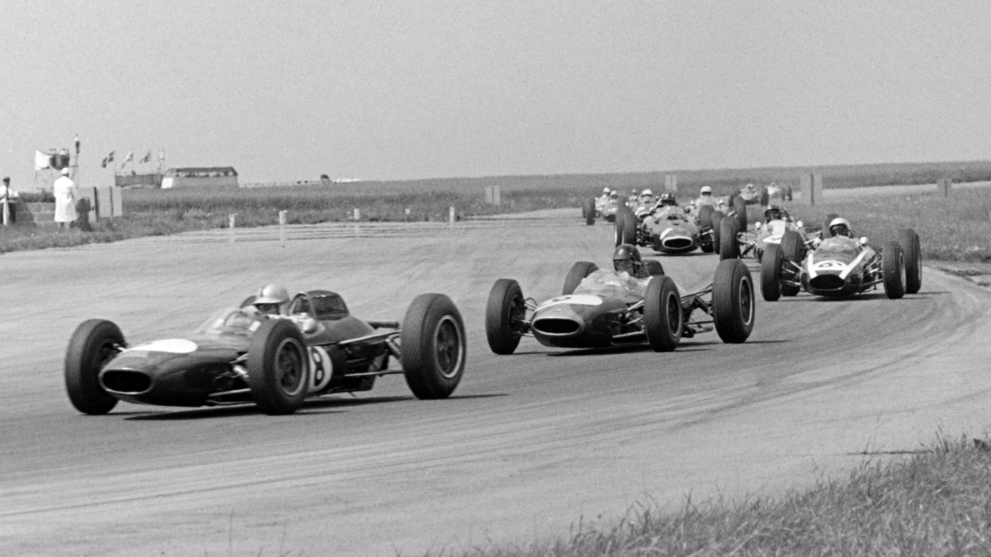 The Brabham BT7s of Jack Brabham and Dan Gurney lead the British Grand Prix at Silverstone, July 1963.