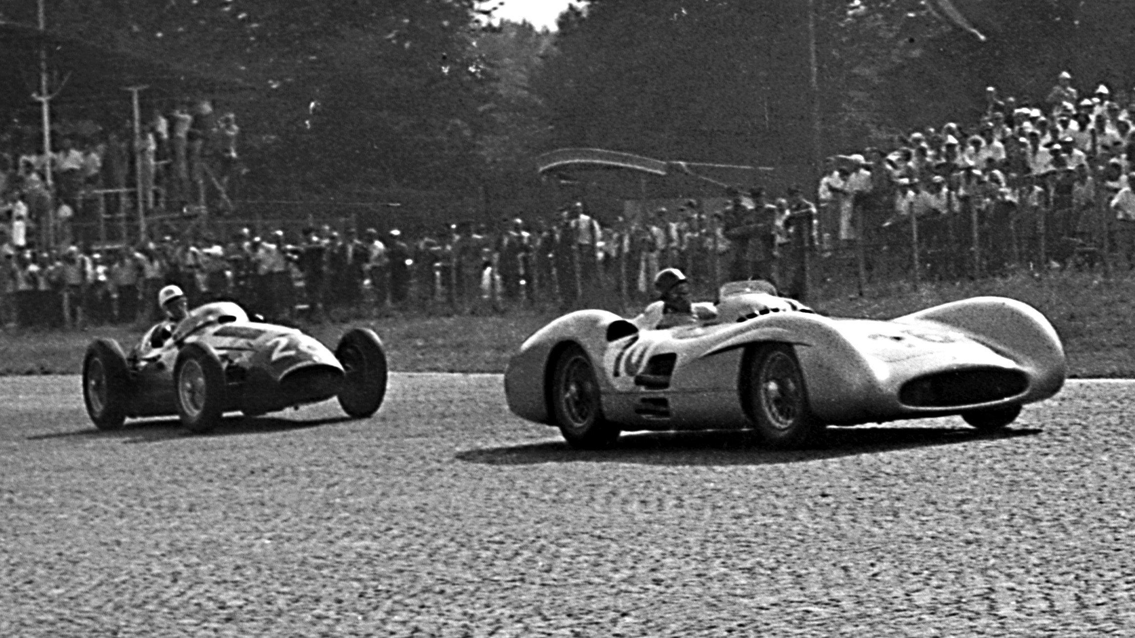 The Mercedes-Benz W196 of Juan Manuel Fangio leads Stirling Moss' Maserati 250F at the Italian Grand Prix, September 1954.