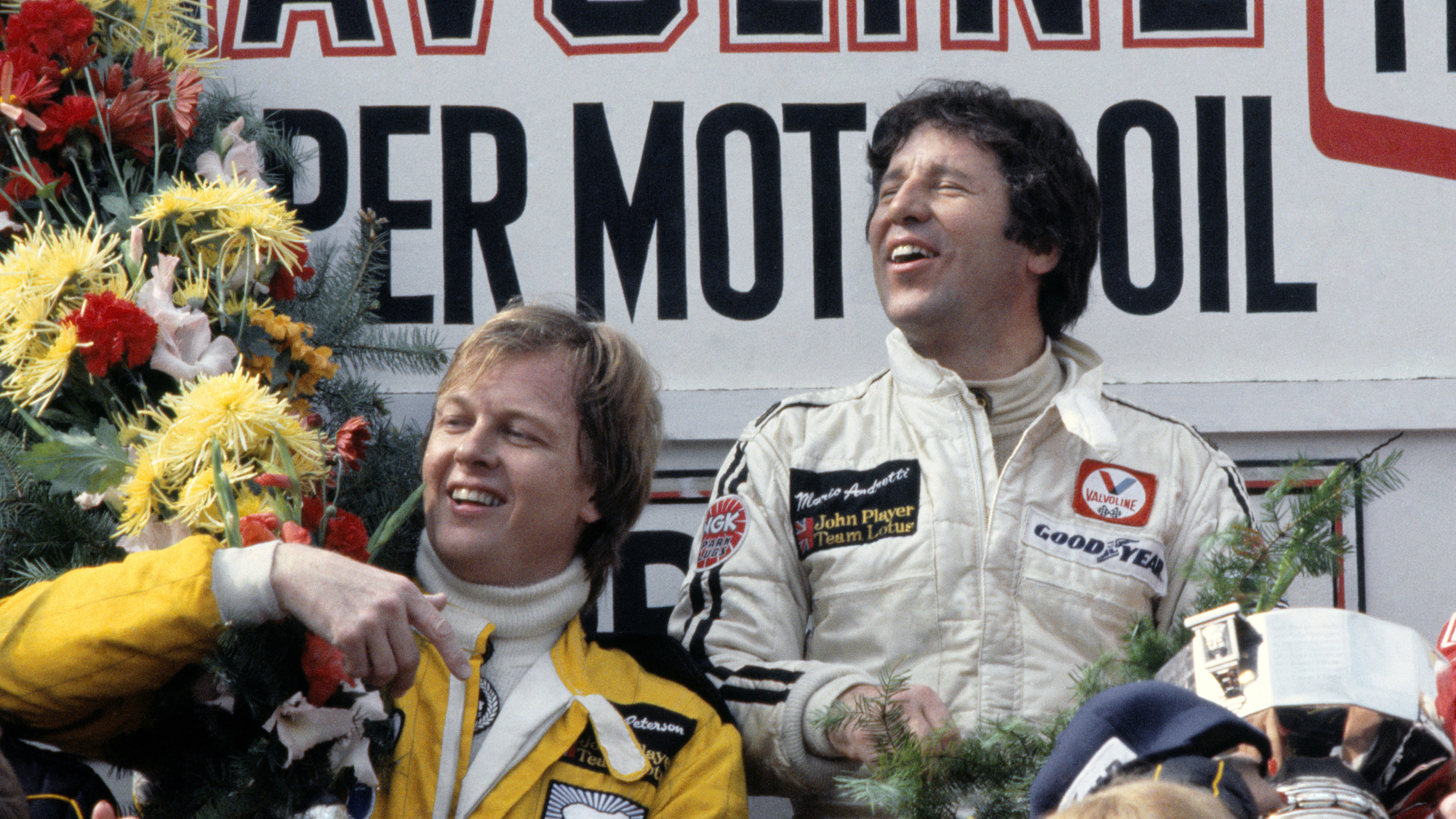 Andretti and Peterson celebrate on the podium after securing a 1-2 finish for Lotus at the Belgium Grand Prix, May 1978.