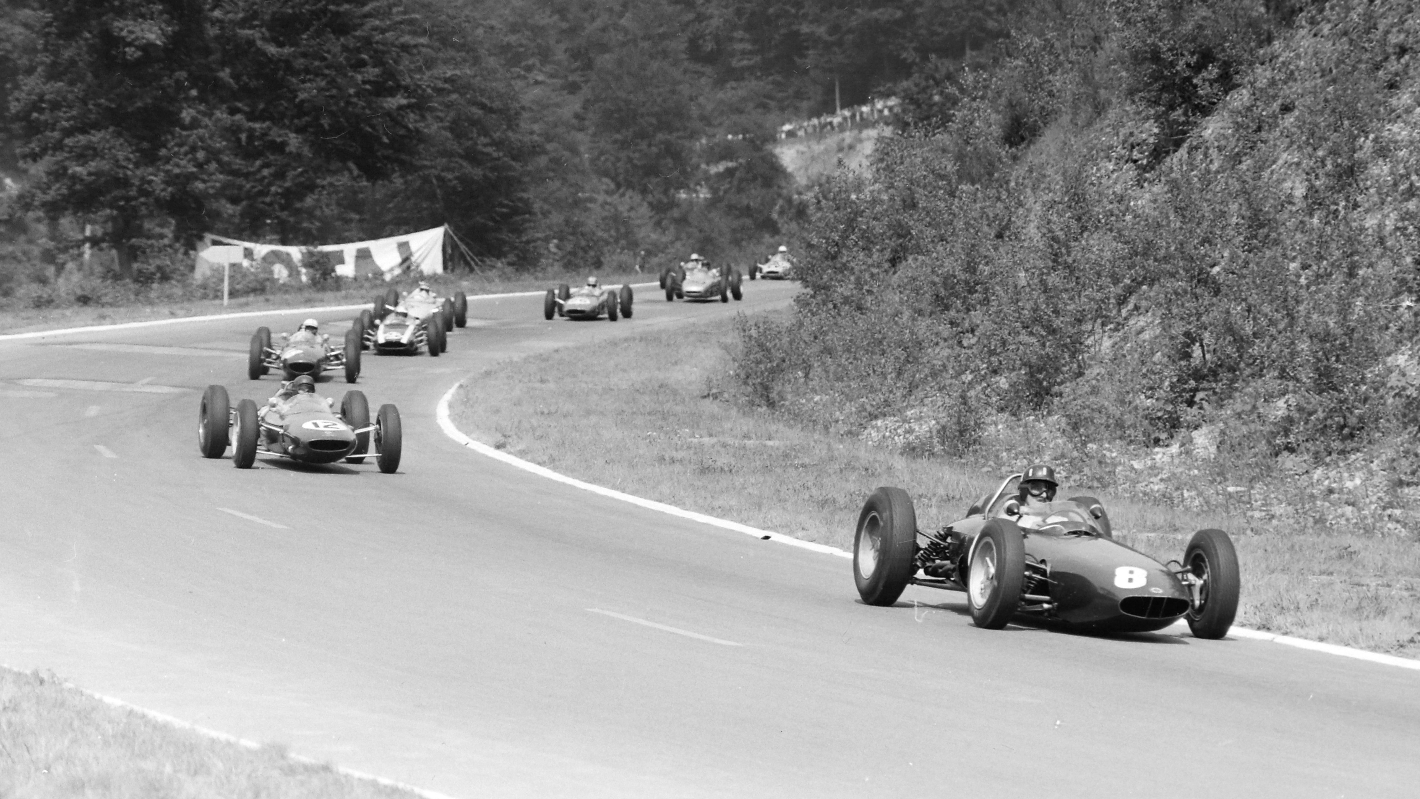 Graham Hill’s BRM P57 leads the Lotus 25 of Jim Clark during the French Grand Prix at Rouen-Les-Essarts, July 1962. 