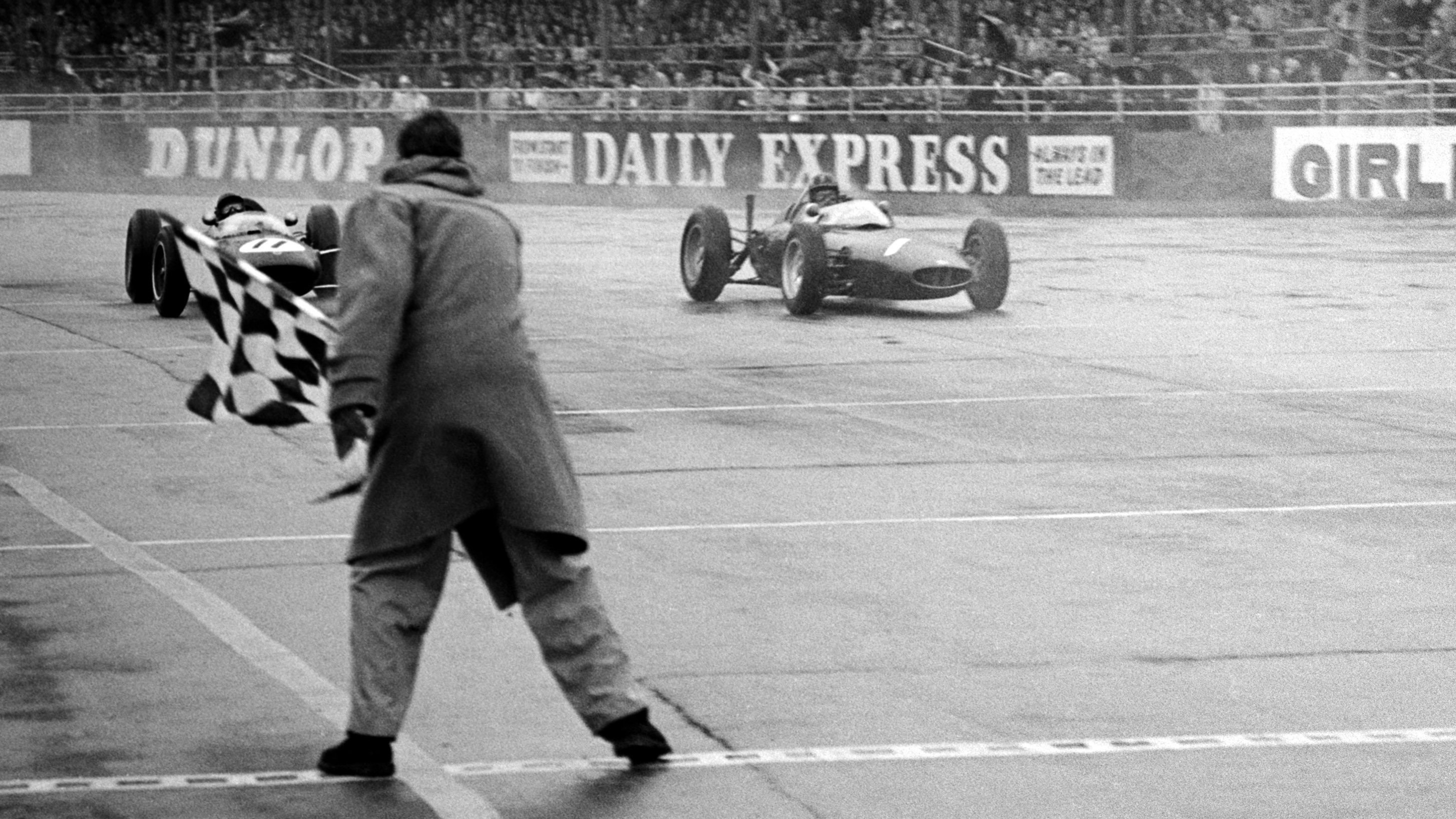 Hill and Clark race to the chequered flag at the BRDC International Trophy at Silverstone, May 1962. The two were recorded the same time but Hill took the win. 