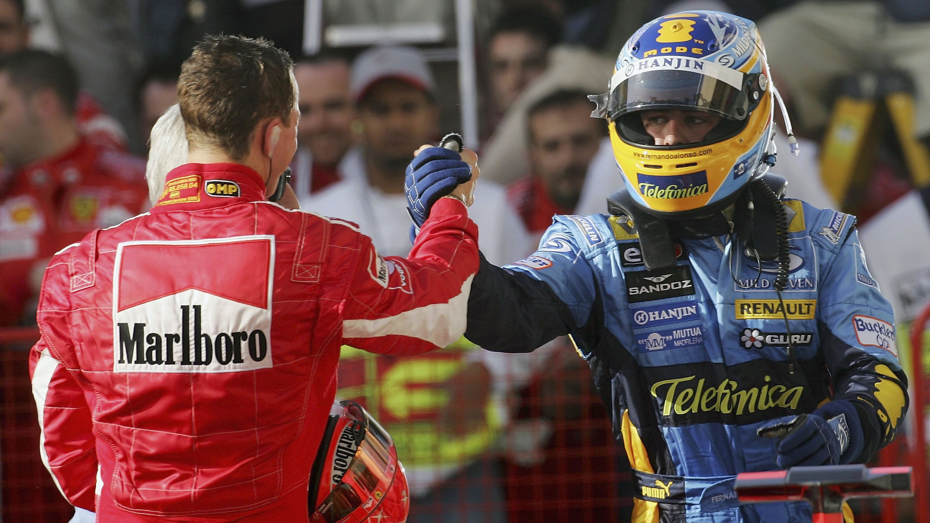 After winning the 2006 Bahrain Grand Prix, Alonso shakes hands with runner-up Schumacher.