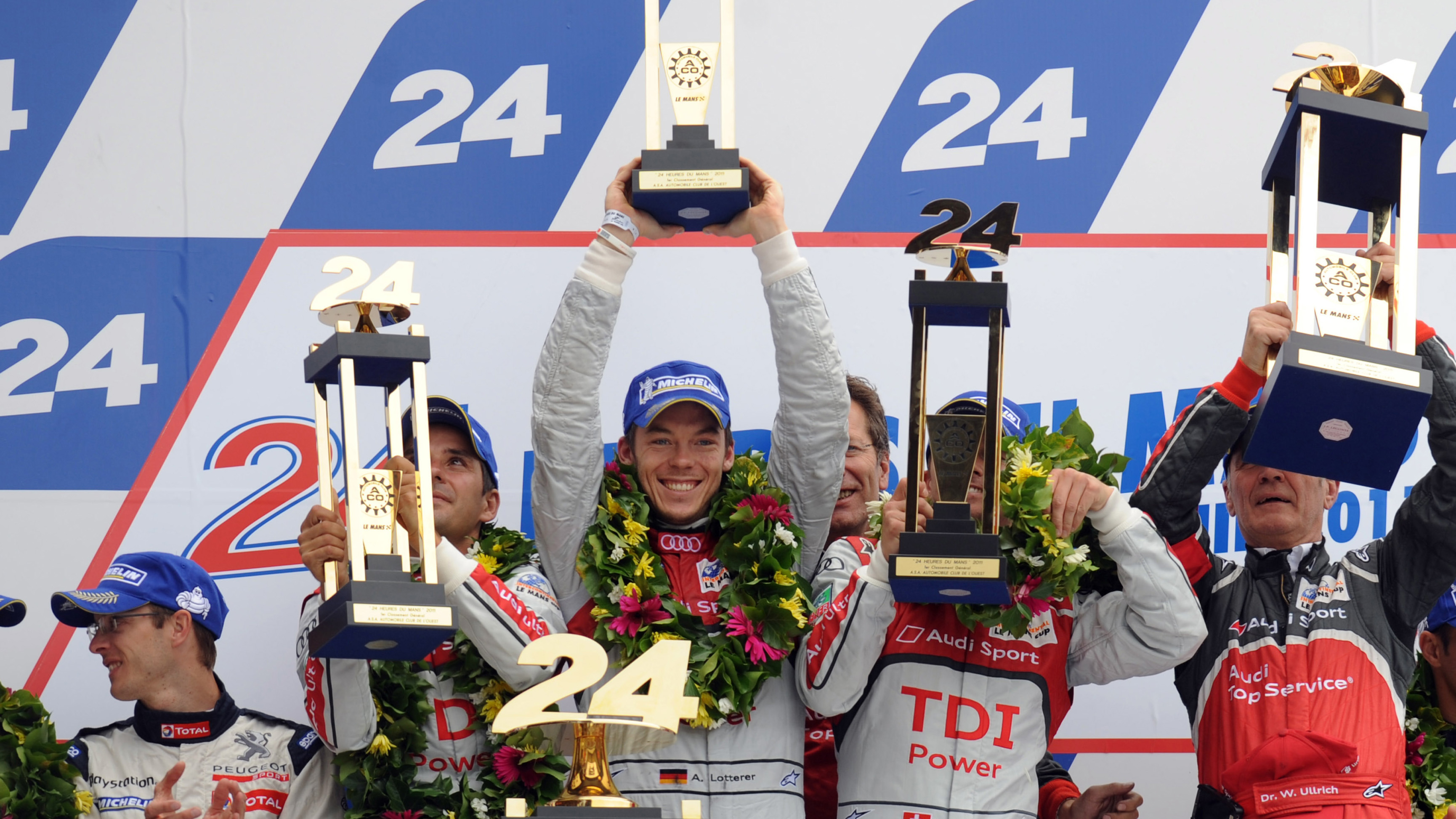 Fassler, Lotterer and Tréluyer celebrate their victory at the 2011 Le Mans 24 Hours with Audi Sport Team Joest.