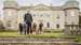 Picture of The Duke of Richmond with four Poodles in front of Goodwood House