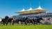 Horses race against the backdrop of the Sussex Stand at Goodwood Racecourse.