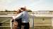 Two guests embracing at the trackside at Goodwood Racecourse. 