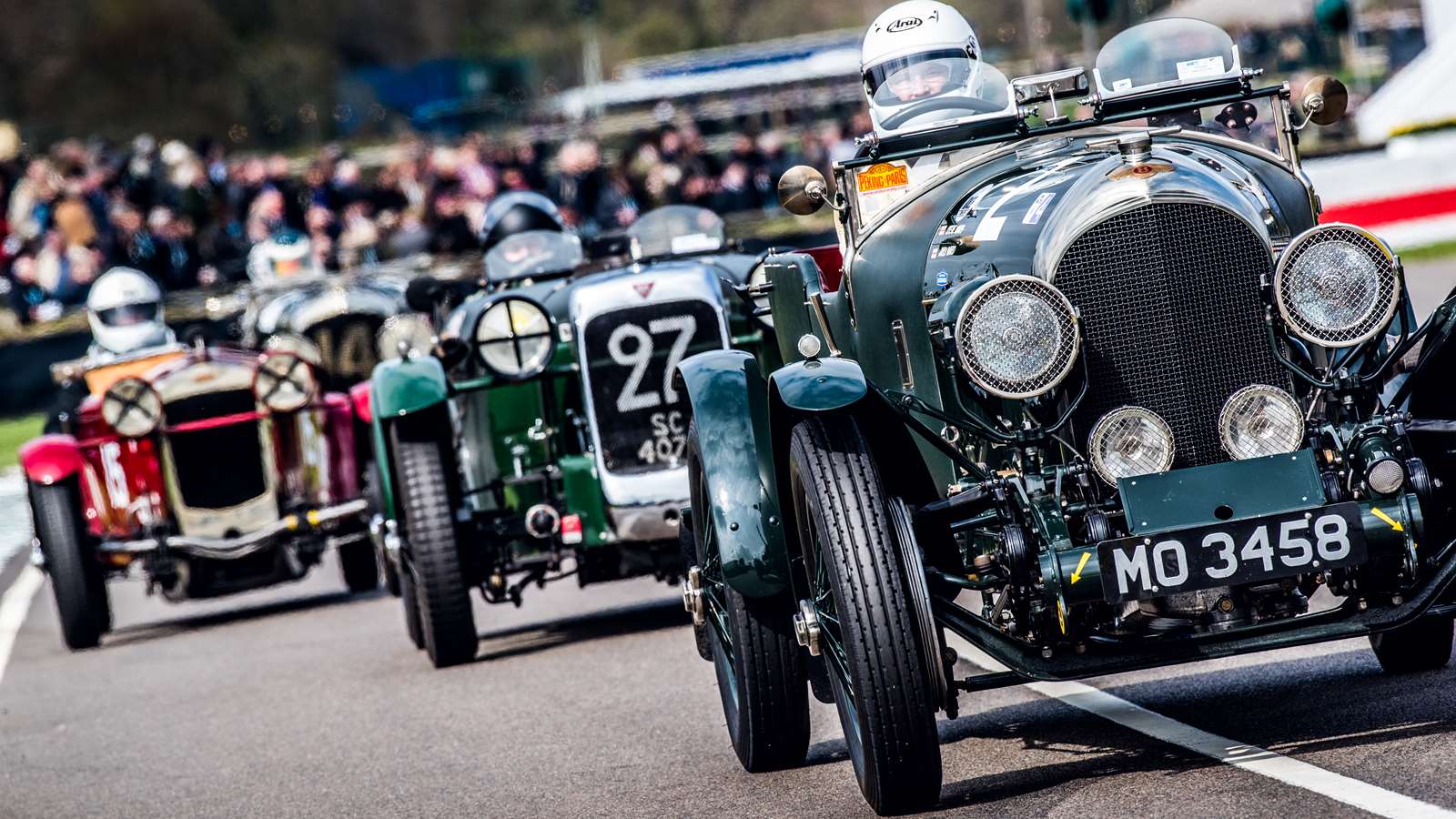 Old cars racing on track at the Goodwood Motor Circuit at the 77th Members' Meeting