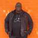 Carl Cox stood in front of orange wall, returning to Three Friday Nights.