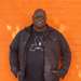 Carl Cox stood in front of orange wall, returning to Three Friday Nights.